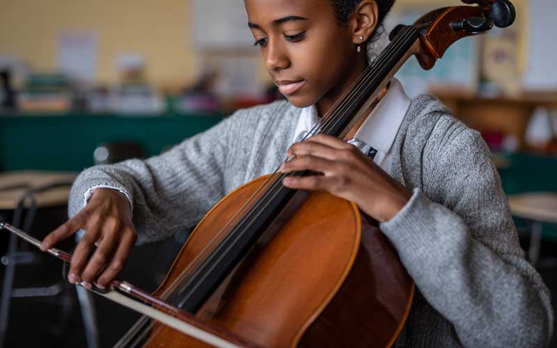 A young girl plays the cello